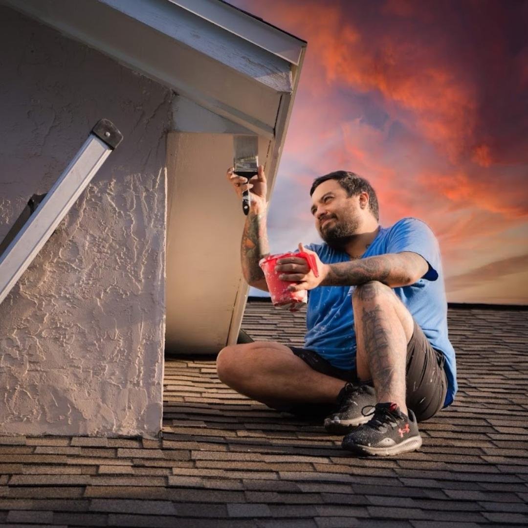 Exterior trim painting on roofline at sunset by Friendly Local Pros